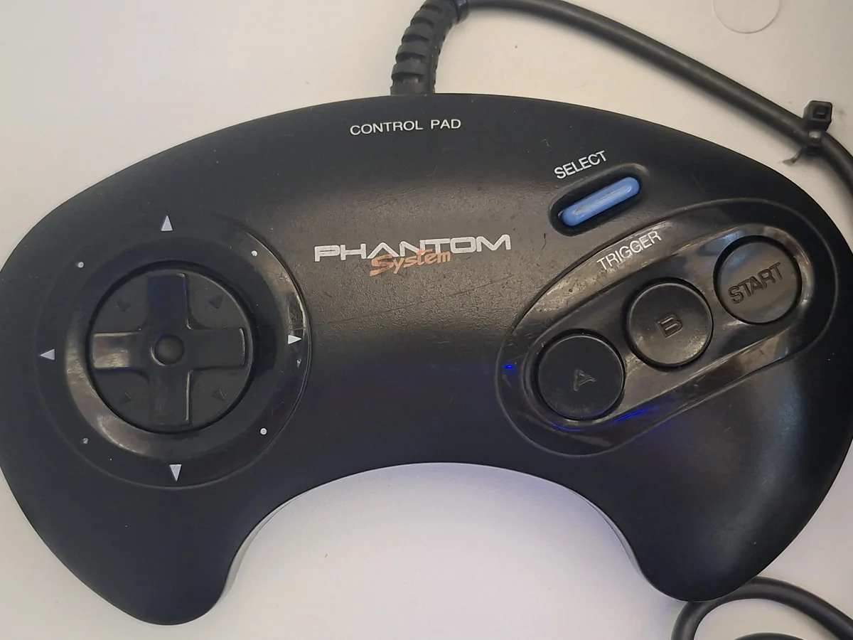 Controle preto do Phantom System com logo PHANTOM System, direcional circular e botões A B Start